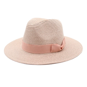 Women's foldable wide brim woven straw sun hat with pink ribbon bow decoration