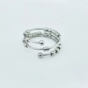 Detailed macro view of silver stainless steel fidget ring with beads and spiral design