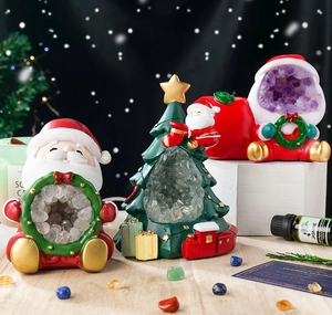 Christmas tree and Santa figurines with natural amethyst and clear crystal caves decoration