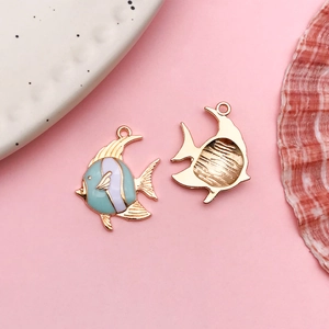 Detailed close-up of cute fish enamel charms with gold plating for DIY jewelry projects
