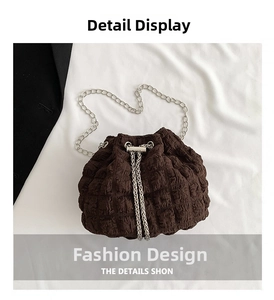 Close-up of dark brown bucket bag featuring bubble crepe fabric texture and silver chain