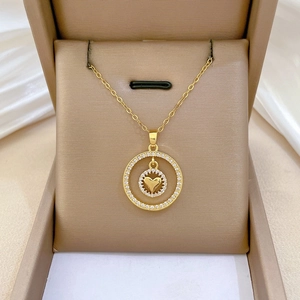 Macro della collana a doppio anello con cuore dorato e cristalli in portagioie