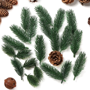 Flat lay of artificial pine needles, pine cones and a rustic bell for Christmas DIY crafts