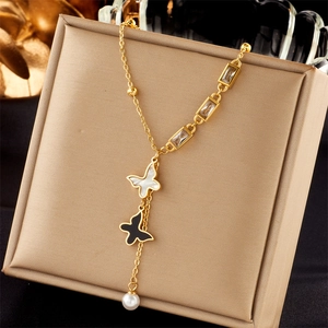 Multi-layered gold titanium necklace with black and white butterfly charms and pearl