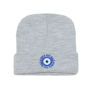Grey knit beanie featuring an Evil Eye embroidery and No Bad Vibes text design