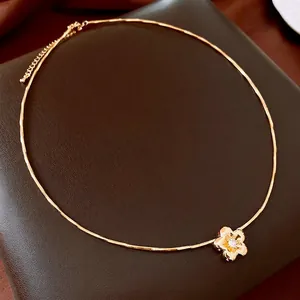 Gold plated snake chain choker necklace featuring a zircon flower pendant on leather