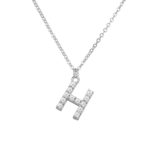 Macro detail of silver H letter pendant necklace featuring delicate inlaid pearls