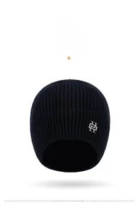 Front view of navy blue ribbed knit ski hat with silver metallic logo emblem