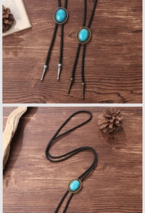 Detail of vintage turquoise bolo tie with braided leather cord on rustic wood background
