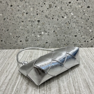 Detailed view of silver metallic woven leather texture with knot handle design