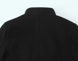 Detail of the high-quality black wool blend fabric and stitching on the stand collar coat