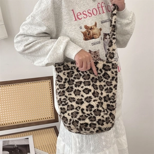 Close-up of leopard print plush shoulder bag showing soft faux fur texture and size