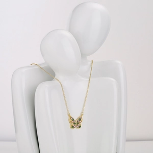Gold plated butterfly necklace with pink and green zircons on white figure display