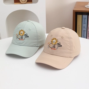 Detail view of cartoon lion embroidery and breathable fabric on kids' sun hats