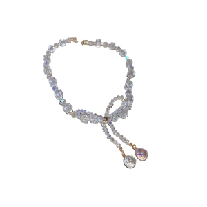 Iridescent crystal bead bow necklace with double pendants on a clean white background
