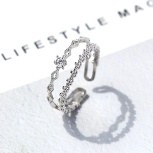 Detail of silver double-layered open ring with hollow rhombus and zircon stone