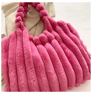 Detail of rose pink faux fur tote bag showing plush vertical quilted striped texture
