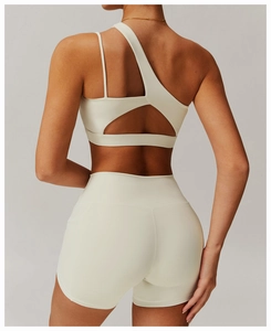 Detail of off-shoulder yoga set with triangular back cutout in creamy white matte fabric