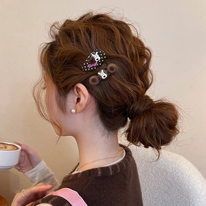 Polka dot puppy hair clip with plush brown pom pom accessories on a female model
