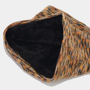 Detail of tie-dye knit neck warmer with thick black fleece lining for winter warmth