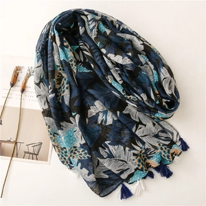 Linen texture navy scarf with leaf prints and tassels on white background