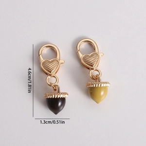Brown and yellow acorn keychains with golden lobster clasps and heart links