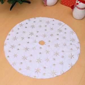 Close-up of white plush Christmas tree skirt with gold and silver snowflake embroidery
