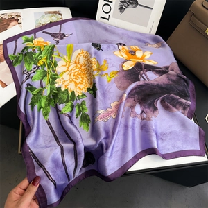 Elegant purple silk scarf with yellow peony and lotus prints in a graceful drape