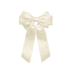 Detail showing the layered satin texture and creamy white finish of the large bow hair clip