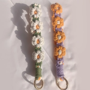 Handmade crochet daisy keychain straps with orange and white flowers and gold rings