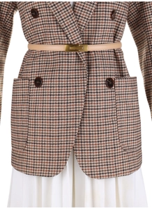 Detail of beige leather skinny belt with gold buckle on plaid blazer for women