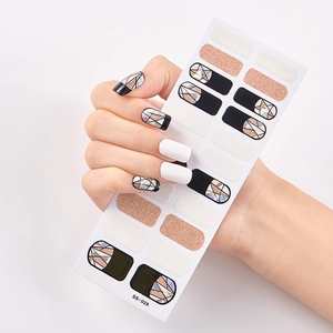 Detail of self-adhesive nail stickers with geometric patterns and gold glitter accents