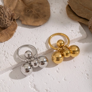 Unique geometric gold and silver stainless steel multi-sphere ring on stone display