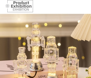 Close-up of four transparent light-up nutcracker soldier figurines with warm LED lights