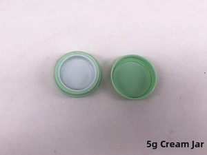Macro detail of a 5g mint green plastic cream jar with white sealing inner gasket