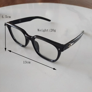 Detailed view of kids square black sunglasses with silver star accents on marble background