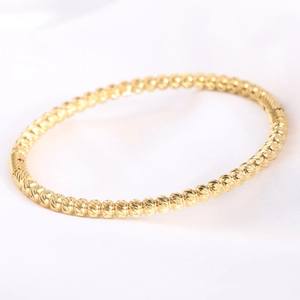 Close-up of 5mm gold stainless steel beaded bracelet with faceted texture detail