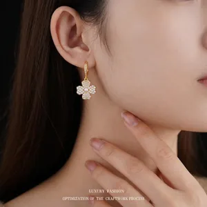 Elegant gold plated clover earrings with cubic zirconia micro-pave and white pearl accents