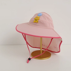 Detail view of pink kids sun hat with wide brim, neck flap and cute cartoon charm