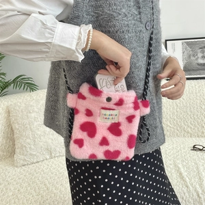 Detail of pink plush heart crossbody bag showing internal space for a smartphone