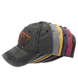 Close-up of vintage washed cotton baseball caps with embroidered patches and curved brims