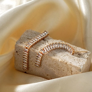Elegant gold C-shaped drop earrings with rectangular zircon inlay on stone and satin