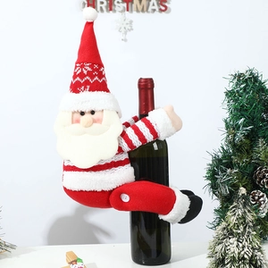 Detail of knitted Santa wine bottle cover with snowflake pattern and plush textures