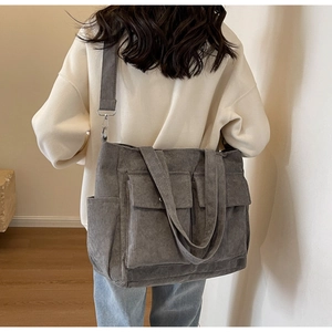 Detailed back view of a grey corduroy tote bag with adjustable straps for daily commute