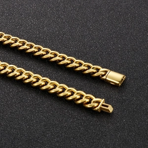 Detailed view of golden Cuban link chain with high-polish finish and secure box clasp