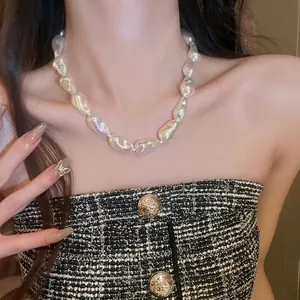 Elegant baroque pearl necklace worn by a model, featuring irregular pearls on a collarbone