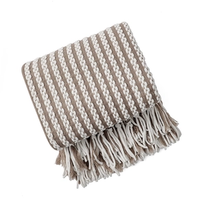 Handmade beige chunky knit blanket with elegant woven textures and decorative tassels