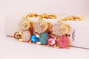 Detailed view of crystal-studded sheep keychains in gold finish with sparkling colorful gems
