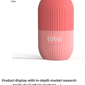 Close-up of pink capsule facial ice roller with non-slip vertical texture and logo area