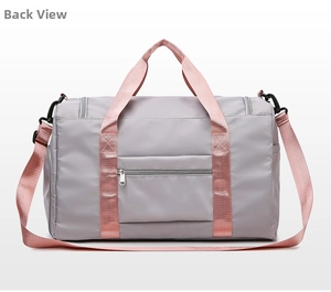 Rear view of grey travel bag featuring a pink strap and a zipper pocket for storage